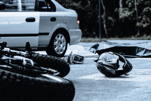 oregon ohio motorcycle accident aftermath, fender pieces, bike, and helmet laying on pavement