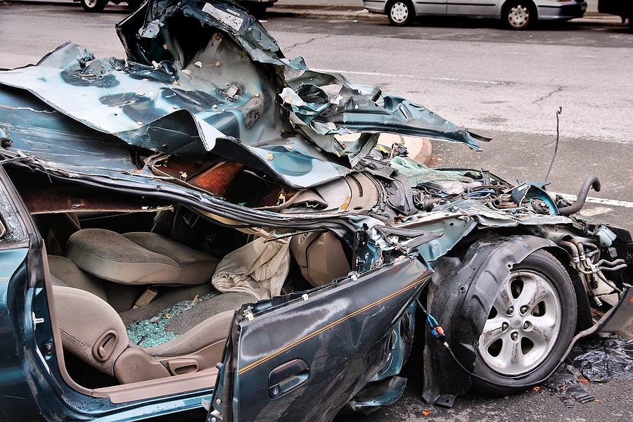 Generic compact car damaged in a rollover accident. Car crash wreck. Personal injury accident.