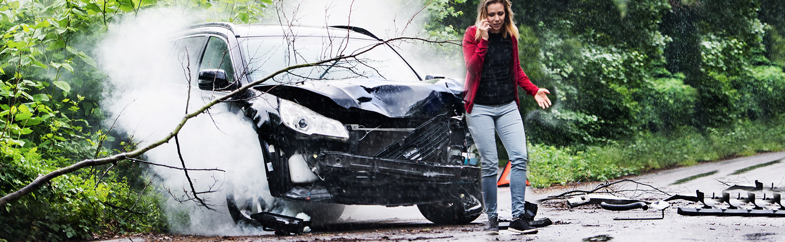 woman standing next to car after an accident calling a personal injury attorney