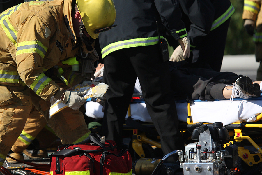 Emergency crew removing a victim from a car accident