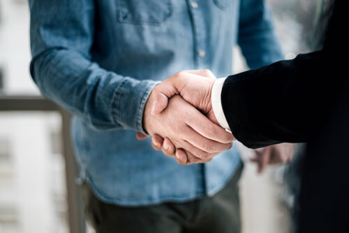 Accident victim shaking hands with his attorney after a settlement.