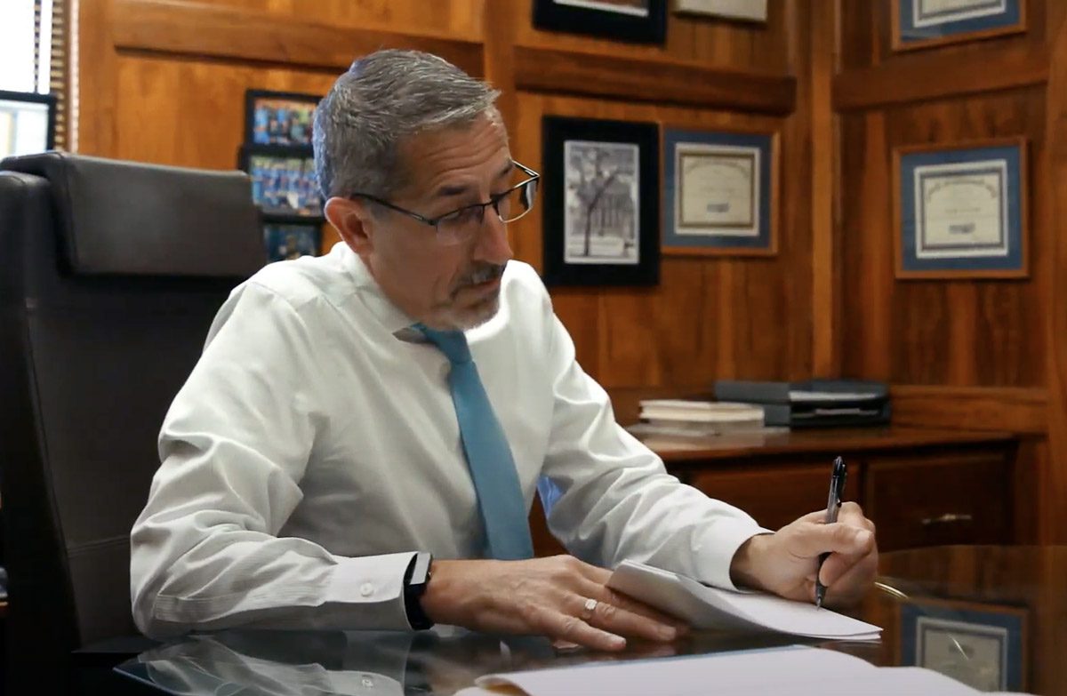 Attorney Dan Michele at desk