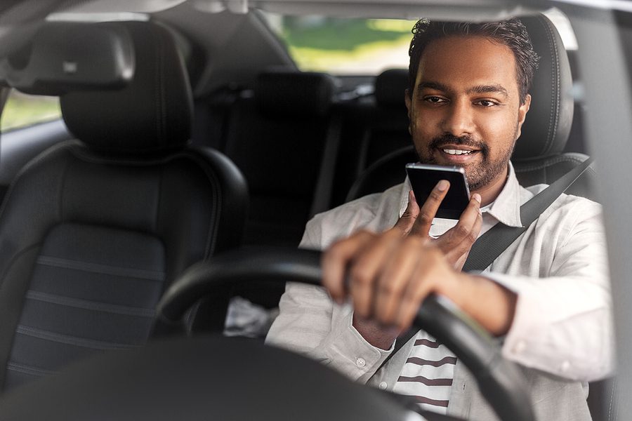 Man talking into his phone with hands free texting.