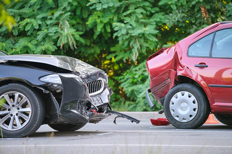 Two car accident involving two sedans - one car with damage to the front, one with damage to the back