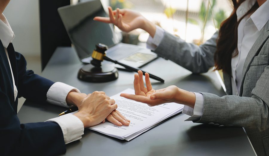 Business law concept, Lawyer business lawyers are consulting lawyers for women entrepreneurs to file copyright lawsuit with laptop and tablet at office