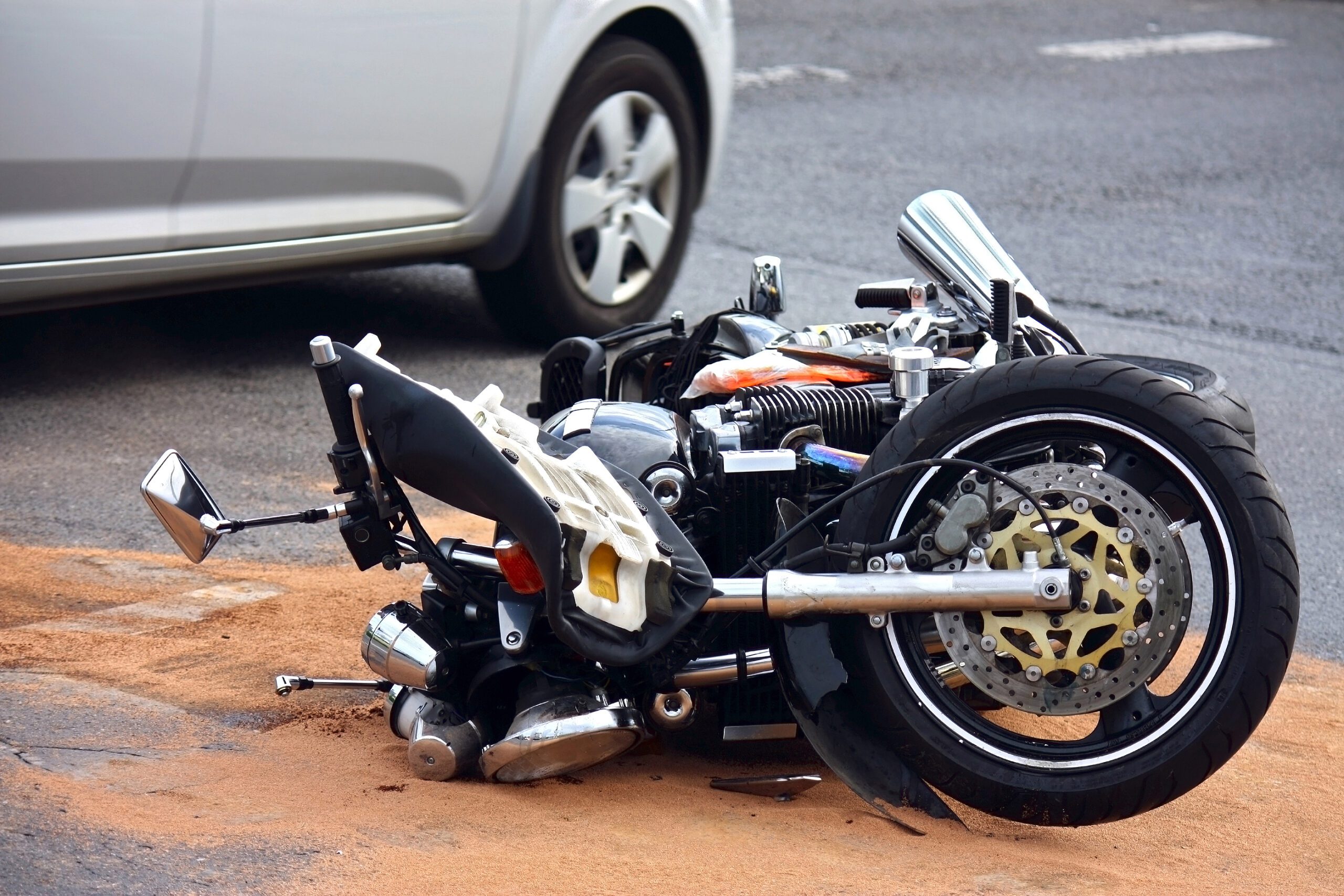 motorcycle laying on road after an accident
