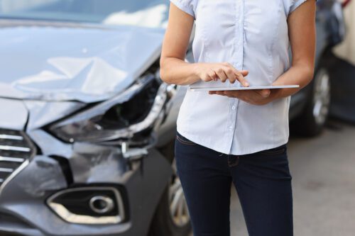 insurance adjuster assessing damages in a car accident