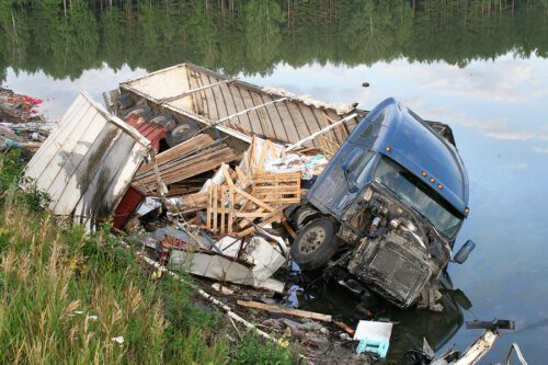 Semi truck accident where a semi truck has fallen into the Maumee river., in Maumee Ohio. The sides of the truck are torn off.