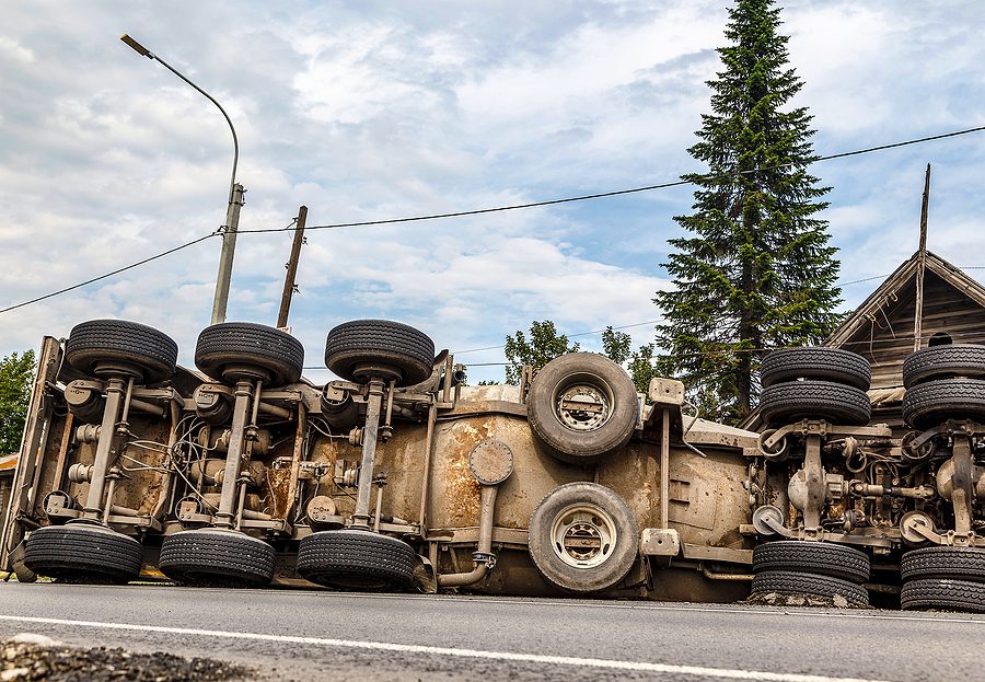 Accident on mountainous road, overturned and lying in ditch on side