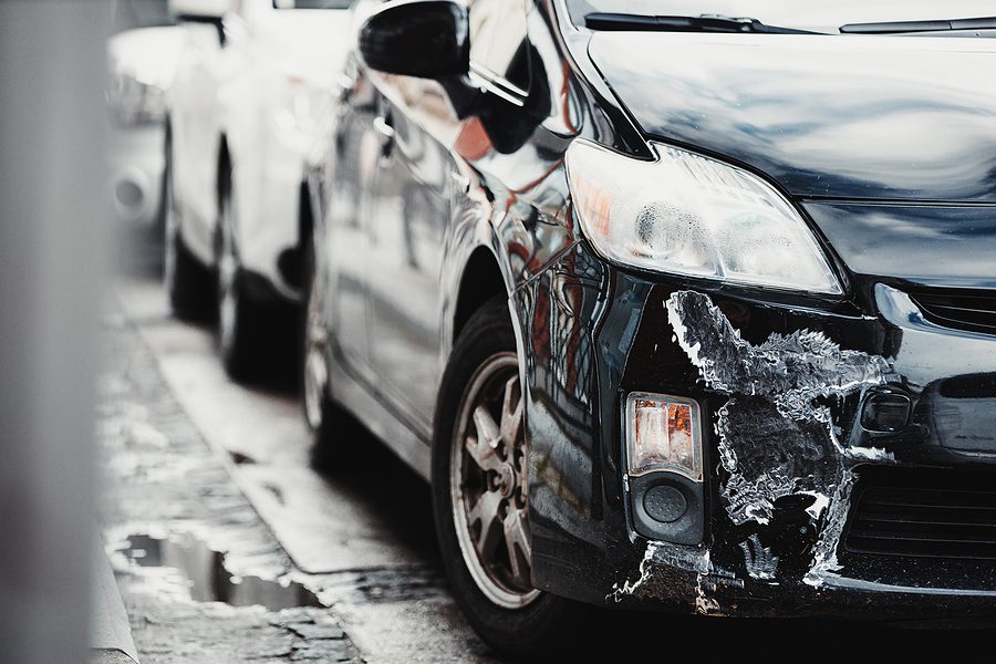 Broken Scratched And Dented Car after Collision.