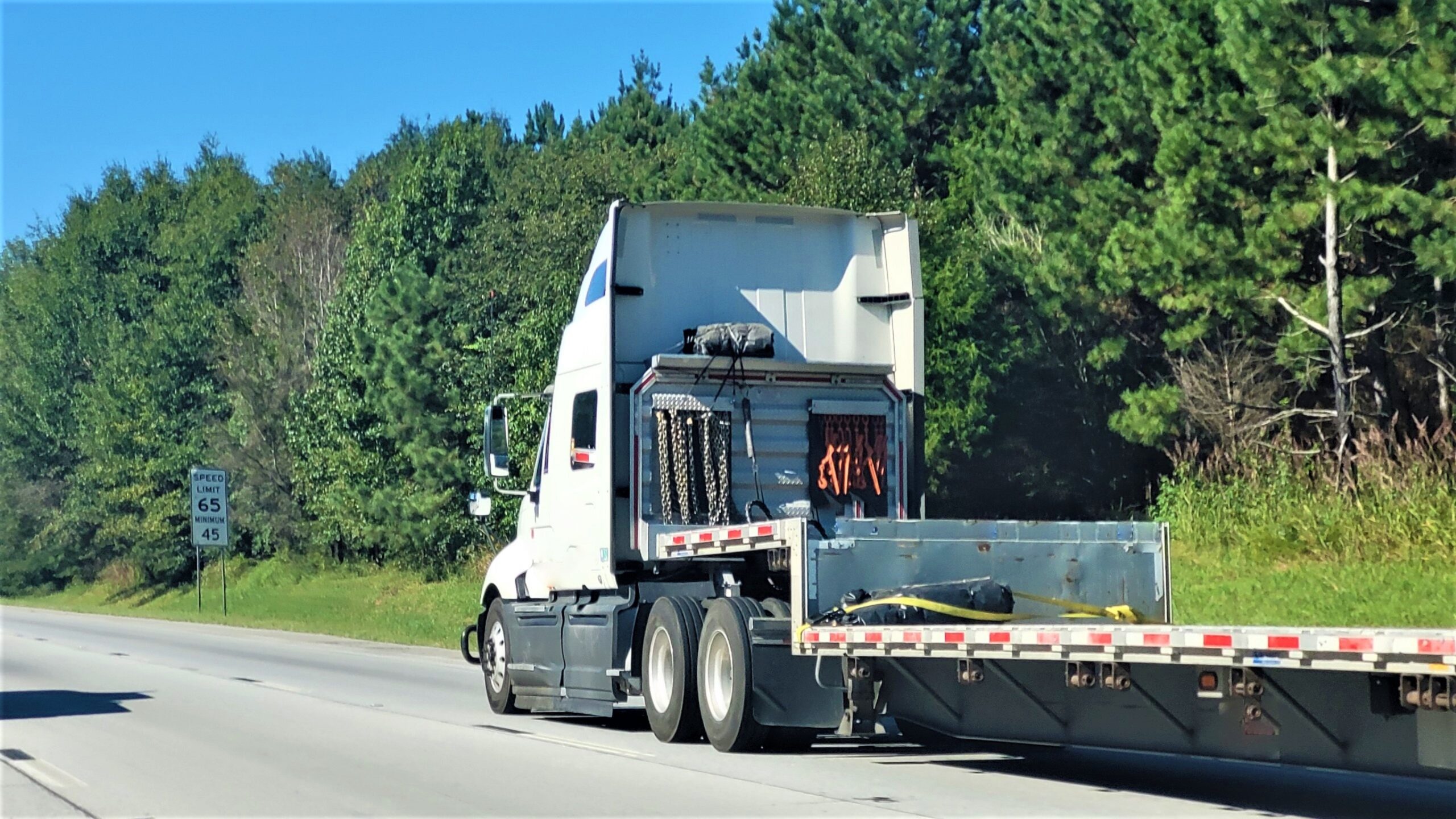 Truck With Flatbed trailer on speed restricted road near Fremont, Ohio