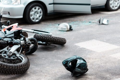 Overturned motorcycle and helmet on the street after collision with a car in Wauseon, Ohio