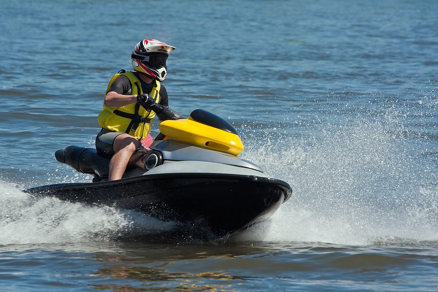 Man riding a jet ski on a lake. 