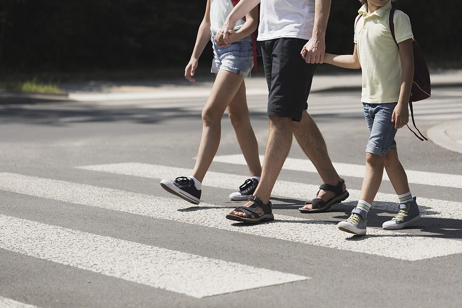 Family walking in a cross walk in Holland OH