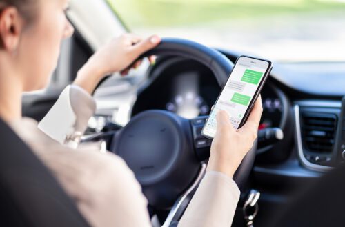 Woman text messaging while driving. 