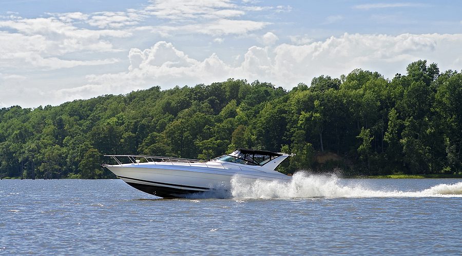 Large speed boat cruising down a river. 