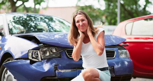 Female holding her neck after a car accident. 