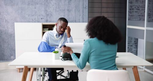 Injured man having a meeting with female attorney. 